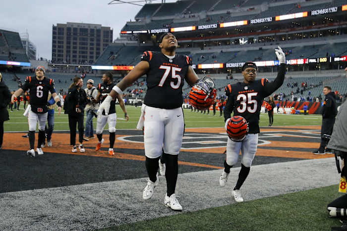 Dec 10, 2023; Cincinnati, Ohio, USA; Cincinnati Bengals offensive tackle Orlando Brown Jr. (75) and cornerback Jalen Davis (35) celebrate the win following the second half against the Indianapolis Colts at Paycor Stadium. Mandatory Credit: Joseph Maiorana-USA TODAY Sports  